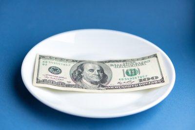 Hundred dollar bill on plate