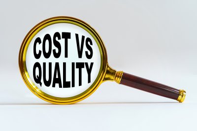 magnifying glass with cost vs. quality